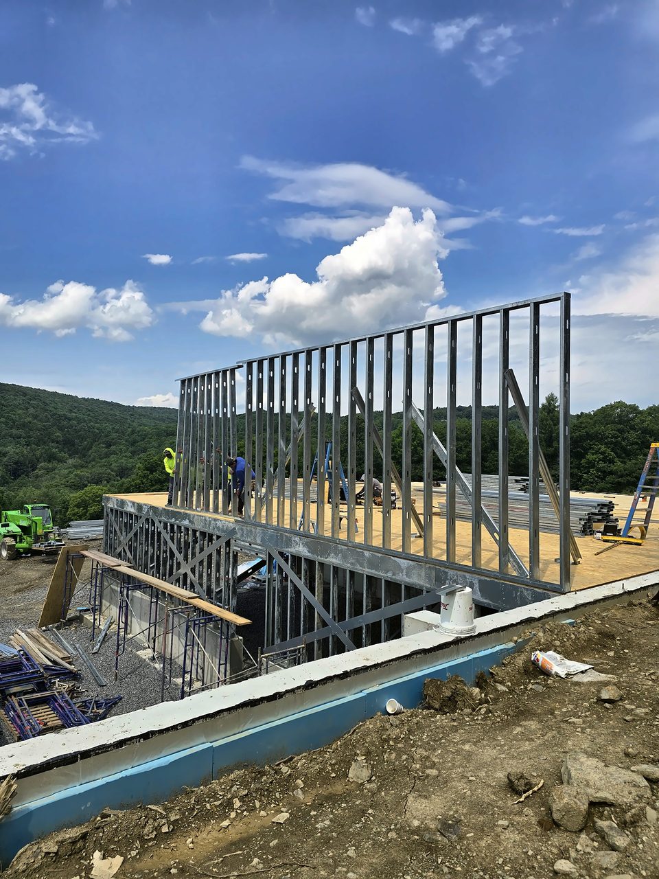 Cold-formed steel wall panels going up on a hillside home site