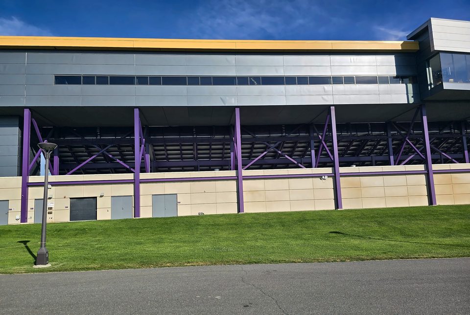 Repainted purple steel columns and bracing on the rear of Casey Stadium at the University at Albany